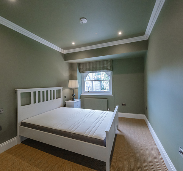 hand holding a paint roller applying black paint on metal surface showing renovation process with emphasis on creativity and precision in painting techniques for project number six