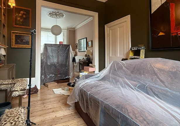 modern bedroom with green walls and a white bed showcasing a bright interior design ideal for relaxation and comfort