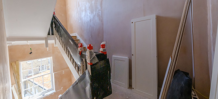 spacious event room with modern furniture and large windows featuring natural light ideal for gatherings seating for 11 guests